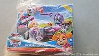 Box front view showing full packaging of Paw Patrol Skye's Ride N Rescue Transforming Helicopter toy with colorful artwork and branding.