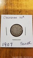 Front side of the 1907 Canadian 10 cents silver coin showing the crown and Canadian coat of arms.
