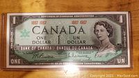 Front side of 1967 Canadian Centennial One Dollar Banknote featuring Queen Elizabeth II and official markings