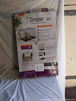 Front view of the MidWest Homes for Pets dog crate packaging showing product features and photo of the crate assembled.