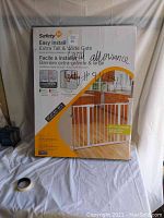 Front view of the Safety 1st Easy Install Extra Tall & Wide Gate packaging with usage and installation details.