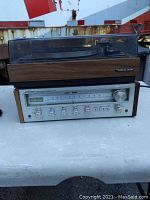 Rear and top view of the Pioneer SX-450 stereo receiver with Realistic R-8000 turntable on top, showing wood paneling and clear dust cover.