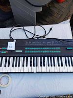 Top-down view of full keyboard with power cable attached, lot number tape visible