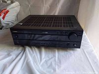 Front view of black Yamaha HTR-5540 AV receiver showing control buttons, volume knob and Yamaha branding.