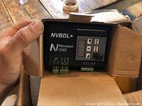 NVBDL+ brushless motor driver without hall sensor in open box showing front display panel and connectors.