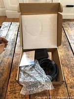 Digital inspection endoscope device packed in original box with bubble wrap, manual sheet, screen, cable, and camera probe visible.