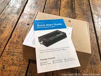 Quick Start Guide with image of Actiontech MoCA 2.5 Network Adapter, showing package contents list.