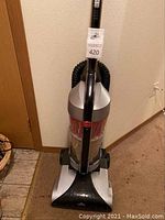 Full upright Hoover WindTunnel vacuum cleaner showing body, handle, dust container, and hose.