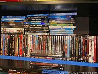Shelf with a wide range of DVDs including titles like Bourne Legacy, Safe House, The Illusionist, and Jeff Dunham Shows.