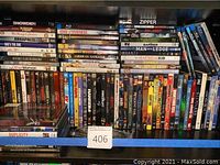 A set of DVDs including Snowden, Zipper, and others organized on a shelf.