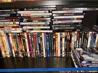 Photo of DVDs and Blu-rays arranged on black shelving with titles visible on spines.