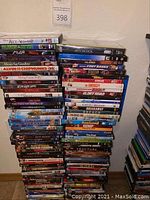 Stack of DVDs with various movie titles visible, showing quantity and packaging condition.