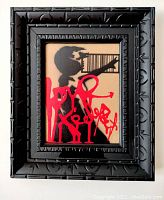 Front view of framed mixed media artwork showing stencil globe and red graffiti signature
