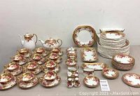 Full set arranged showing tea cups, saucers, plates, pots, and serving pieces