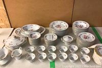 Overview of full 91-piece Noritake dinnerware set on table