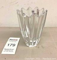 Front side view of the clear Orrefors crystal vase showing scalloped top edge and vertical facets