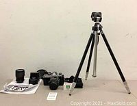 Overview of camera, lenses, tripod and accessories on table