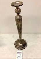 Full view of the Wallace sterling silver candlestick showing tapered fluted stem and lobed hexagonal base.