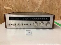 Front view of vintage Sony STR-2800 stereo receiver showing wooden sides and stainless steel front panel with controls and tuning dial.