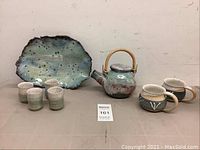 Full set of 8 handmade pottery pieces including platter, teapot, mugs, and small cups