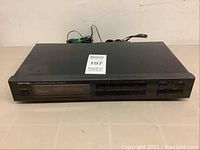 Front view of the Rotel RT-930AX AM/FM stereo tuner showing display, labeled buttons, and power switch.