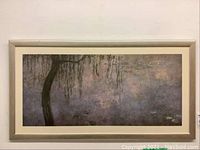 Full view of framed art print hanging on wall showing entire image and frame.