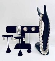 Photo of the full jewelry set displayed on stands including necklace on hand stand, earrings on black holders, and bangle bracelet on horizontal holder.