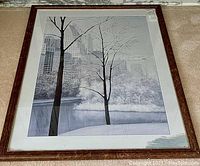 Frontal view of framed print showing the artwork and stained mat with brown wood frame.