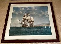 Framed print of sailing ships at sea under a cloudy sky