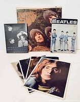 Photo showing Life With The Beatles book, Rubber Soul LP, The Beatles Now And Then book, and several photo inserts of The Beatles.