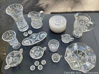 Overview of the collection showing variety of shapes and sizes including pitchers, plates, salt and pepper shakers, vase, and decorative bowls.