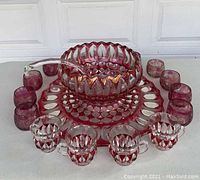 Full set arranged showing bowl, tray, ladle, and cups with distinct dark pink swirl glass pattern and clear glass ladle.