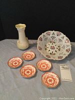 Overall view of the lot showing the Belleek vase, hand-painted Sumi bowl, and five Mintons coasters