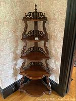 Full view of 5-tier maple corner shelf with scalloped shelves and decorative scrollwork, showing overall structure and condition.