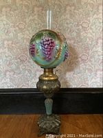 Assembled lamp on hardwood floor in front of wallpapered wall