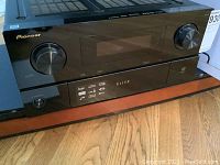 Front view of black Pioneer Elite SC-05 receiver with glossy panel, dual rotary knobs and central display