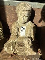 Front view of the sitting Buddha statue showing the seated pose and jewel details on the chest.