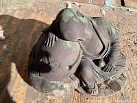 Full view of stone Sleeping Buddha statue lying down, detailed robe and head resting on pillow visible.