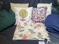 Group photo of all pillows and throws showing embroidery details and colors