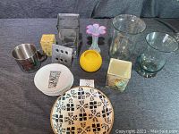 Six cocktail plates, various vases and wood bowl collectively shown from above on table