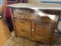 Front view of the white oak dresser showing three drawers and side cabinet with brass handles and white knob on the door.