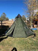 Exterior view of the green Guide Gear tipi style tent set up outdoors, showing the full tent shape, multiple vents, and structure.