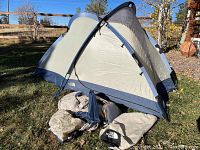 The North Face Talus tent set up outdoors showing its dome shape and color design.