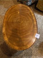 Top view of the oval wooden coffee table showing wood grain pattern and surface condition.