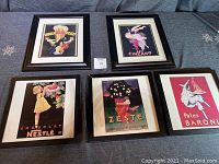 Five framed retro kitchen-themed prints displayed together on a surface, showing different vintage food advertisements, some with frame damage and fading.