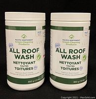 Front view of two unopened containers of All Roof Wash showing brand and label text including weight 850g and price $36.99