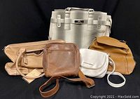 Group photo of five bags including a large textured off-white carry-on tote and four assorted smaller purses in tan, brown, white, and brown shades.