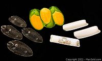 Photo showing seven corn on the cob holders including 4 clear glass plates, 2 ceramic holders, 1 fine china holder.