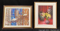 Two wood-framed art prints by John G. Kuyten side by side, showing an abstract scaffolding scene and a floral still life.