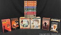 Overall view of multiple VHS box sets and individual movie tapes including Pride and Prejudice, Vanity Fair, Three Stooges, Fiddler On The Roof, Gone With The Wind, Hamlet, and Lawrence of Arabia